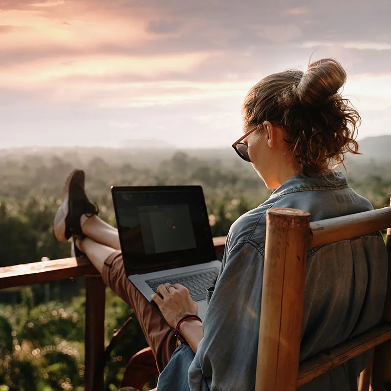 Working on a laptop overlooking the forest